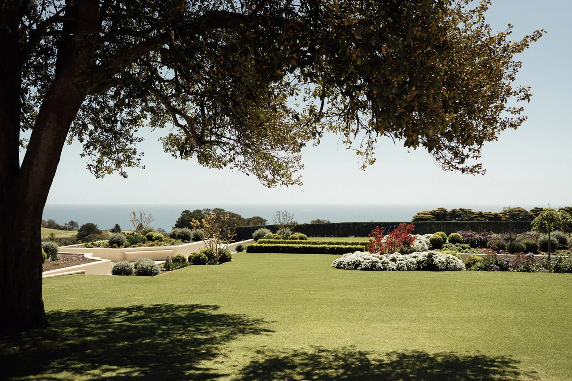 Lawn and manicured gardens at Sunnyside Estate looking out to the ocean