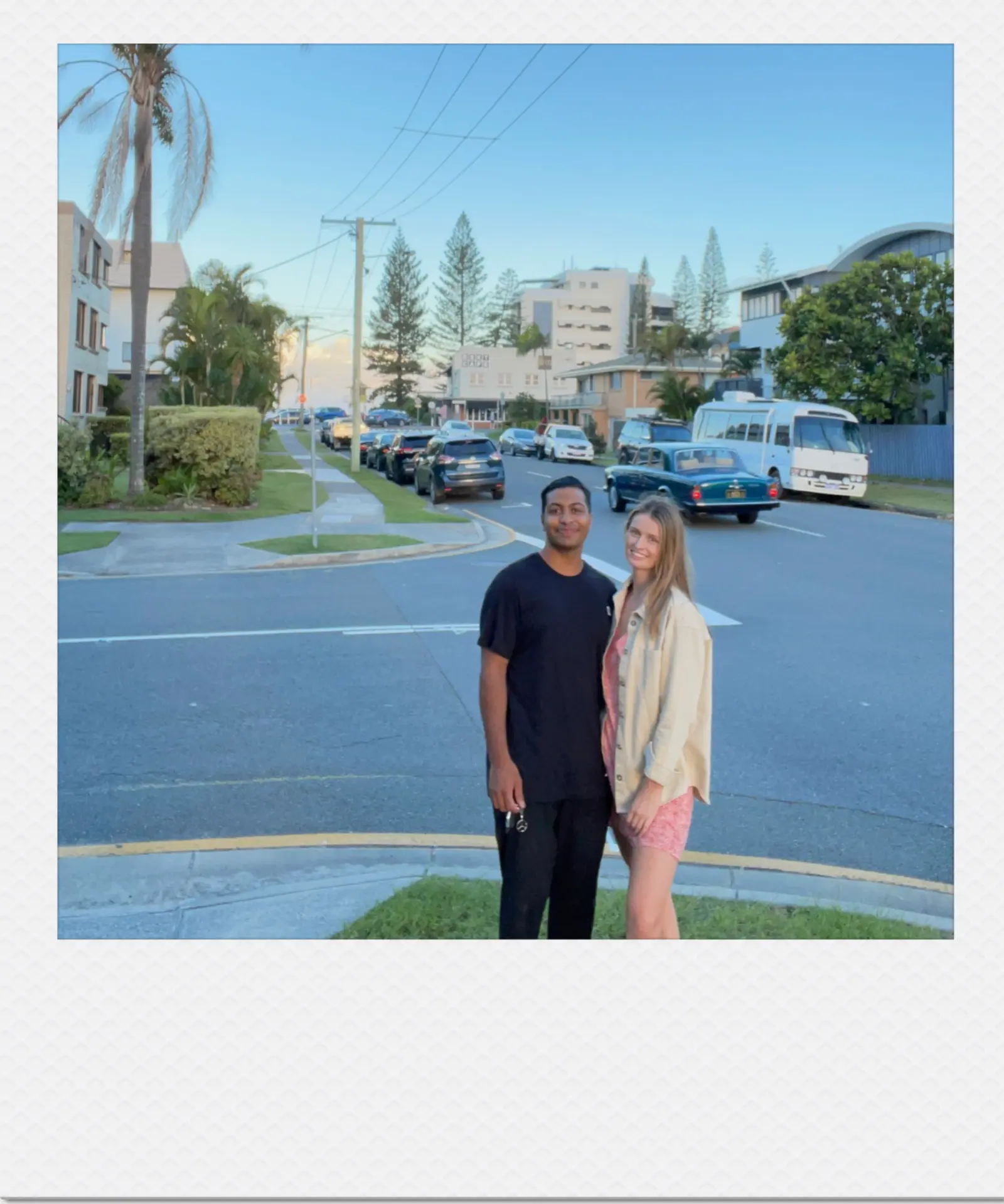 Hannah and Nihal on a coastal street at golden hour